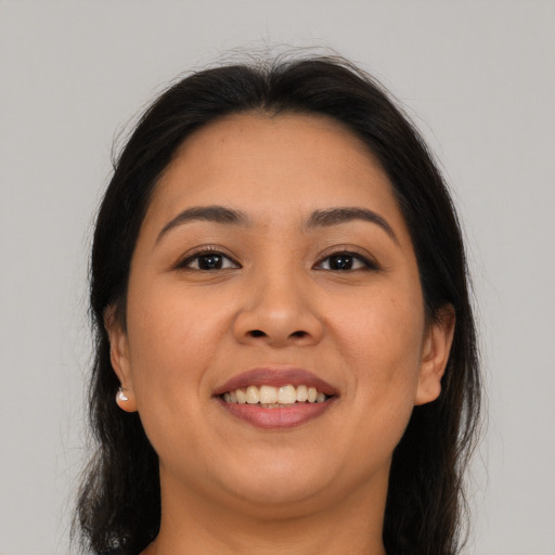 Joyful asian young-adult female with long  brown hair and brown eyes