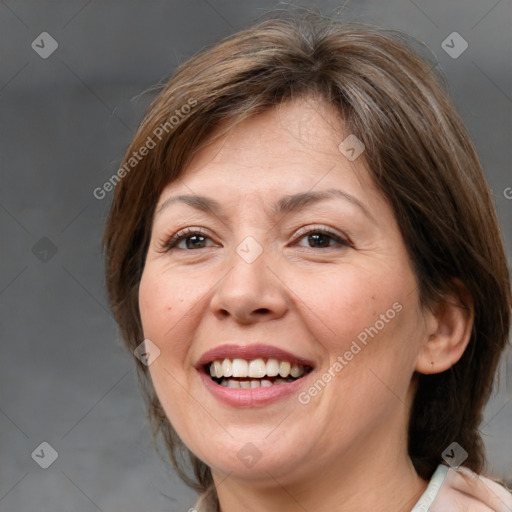 Joyful white adult female with medium  brown hair and brown eyes