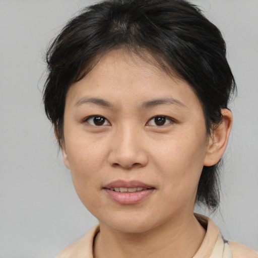 Joyful asian young-adult female with medium  brown hair and brown eyes