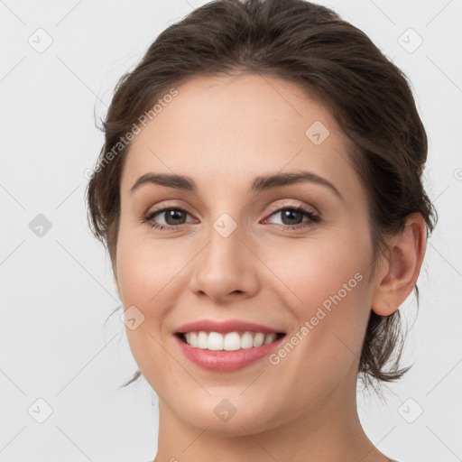 Joyful white young-adult female with medium  brown hair and grey eyes