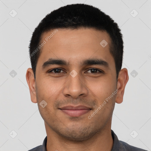 Joyful latino young-adult male with short  black hair and brown eyes