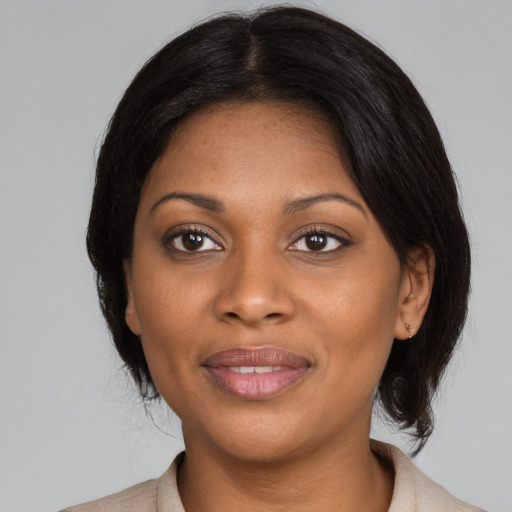 Joyful black young-adult female with medium  black hair and brown eyes