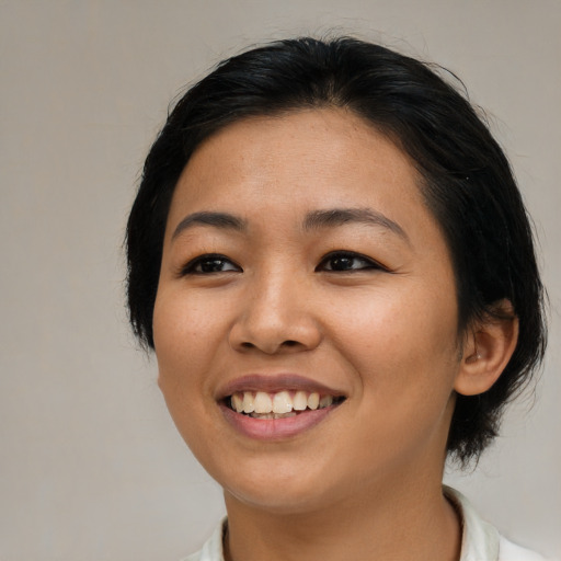 Joyful asian young-adult female with medium  black hair and brown eyes