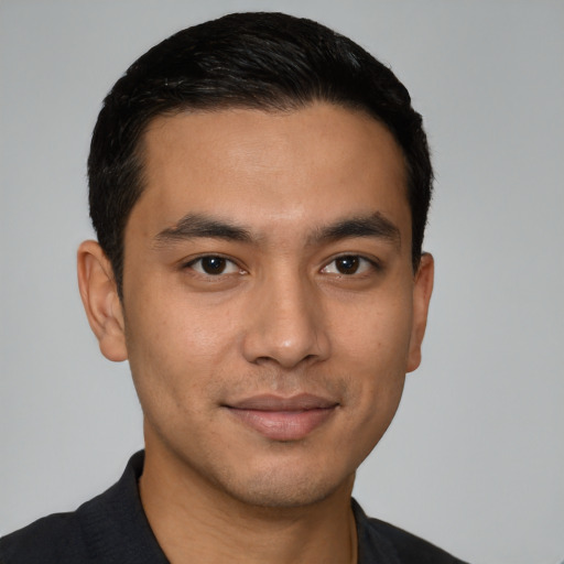 Joyful latino young-adult male with short  black hair and brown eyes