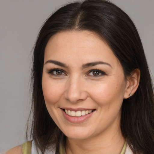 Joyful white young-adult female with medium  brown hair and brown eyes