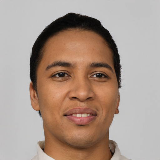 Joyful latino young-adult male with short  black hair and brown eyes