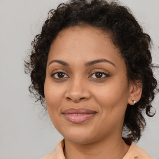 Joyful latino young-adult female with medium  brown hair and brown eyes