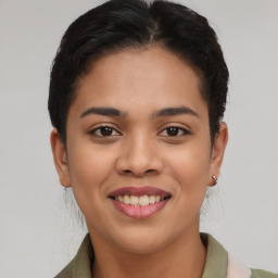 Joyful latino young-adult female with short  brown hair and brown eyes