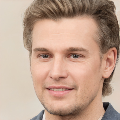 Joyful white young-adult male with short  brown hair and grey eyes