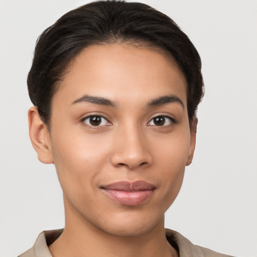 Joyful latino young-adult female with short  brown hair and brown eyes