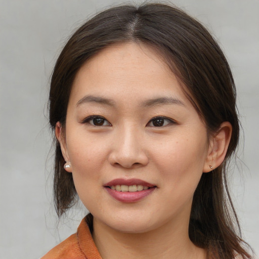 Joyful asian young-adult female with medium  brown hair and brown eyes