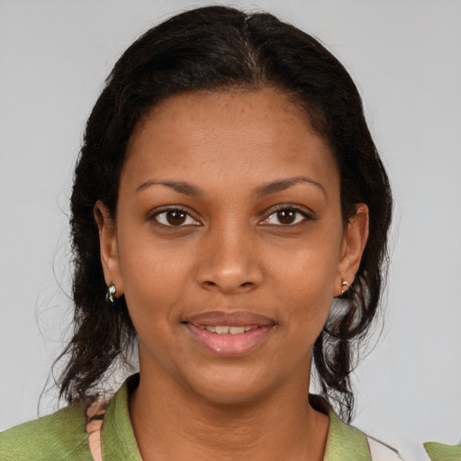 Joyful black young-adult female with medium  brown hair and brown eyes