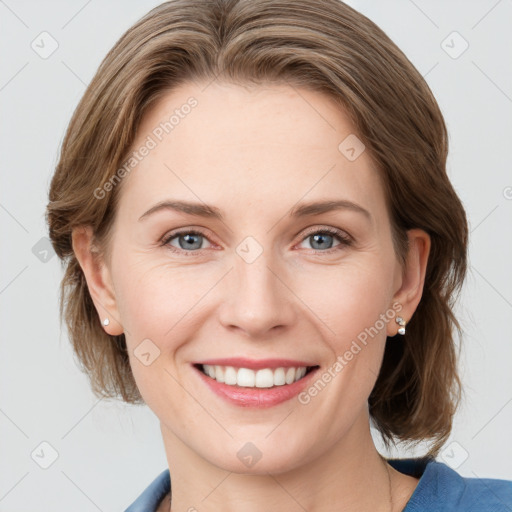 Joyful white young-adult female with medium  brown hair and blue eyes