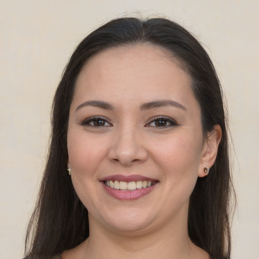 Joyful white young-adult female with long  brown hair and brown eyes