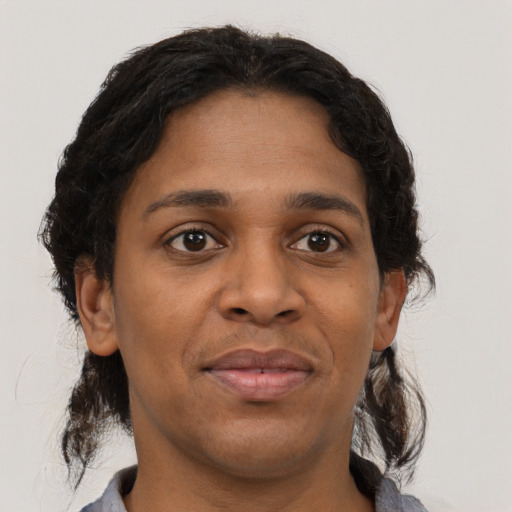 Joyful black young-adult female with medium  brown hair and brown eyes