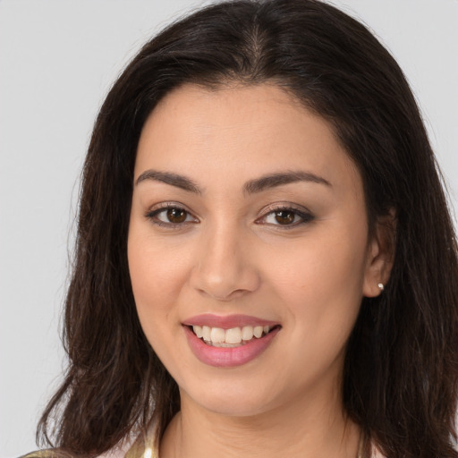 Joyful white young-adult female with long  brown hair and brown eyes