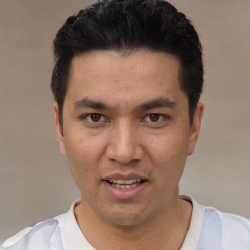 Joyful white young-adult male with short  black hair and brown eyes