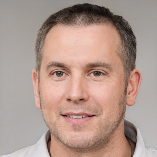 Joyful white adult male with short  brown hair and brown eyes