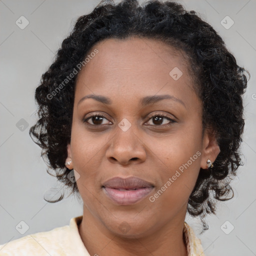 Joyful black adult female with long  brown hair and brown eyes