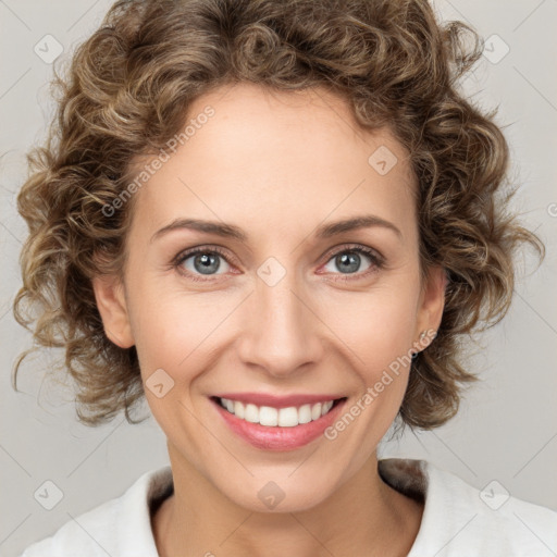 Joyful white young-adult female with medium  brown hair and blue eyes