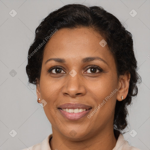 Joyful black adult female with medium  brown hair and brown eyes