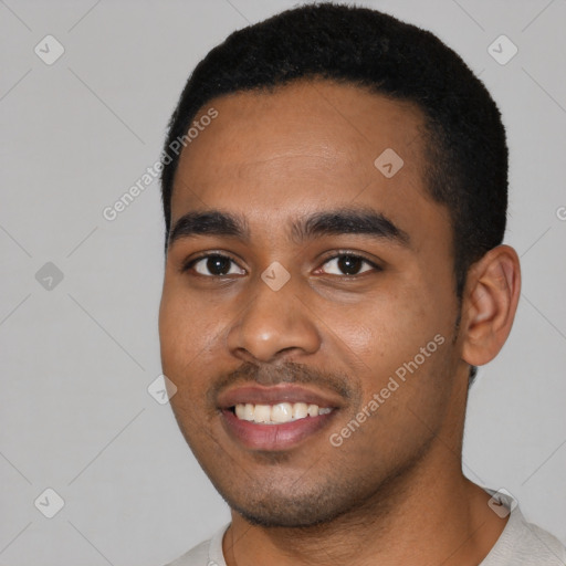 Joyful black young-adult male with short  black hair and brown eyes