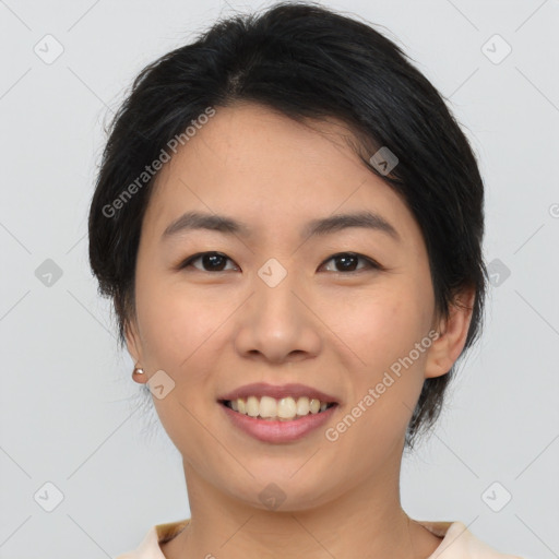 Joyful asian young-adult female with medium  black hair and brown eyes