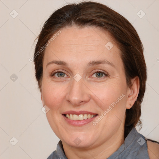 Joyful white adult female with medium  brown hair and grey eyes