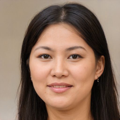 Joyful asian young-adult female with long  brown hair and brown eyes