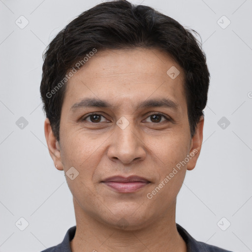 Joyful white young-adult male with short  black hair and brown eyes