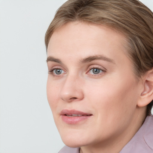 Joyful white young-adult female with medium  brown hair and blue eyes