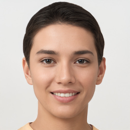 Joyful white young-adult female with short  brown hair and brown eyes