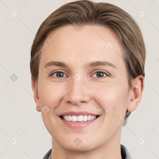 Joyful white young-adult female with short  brown hair and grey eyes