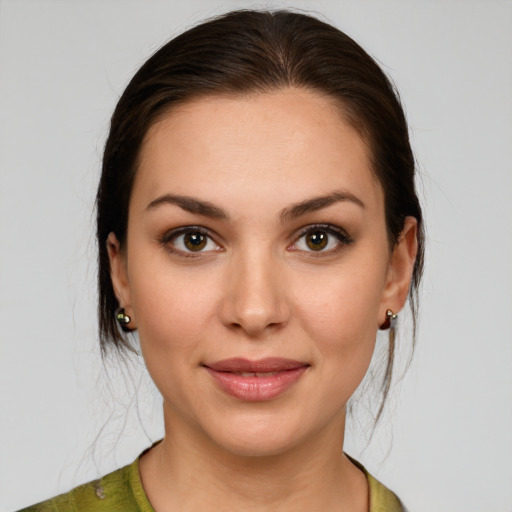 Joyful white young-adult female with medium  brown hair and brown eyes