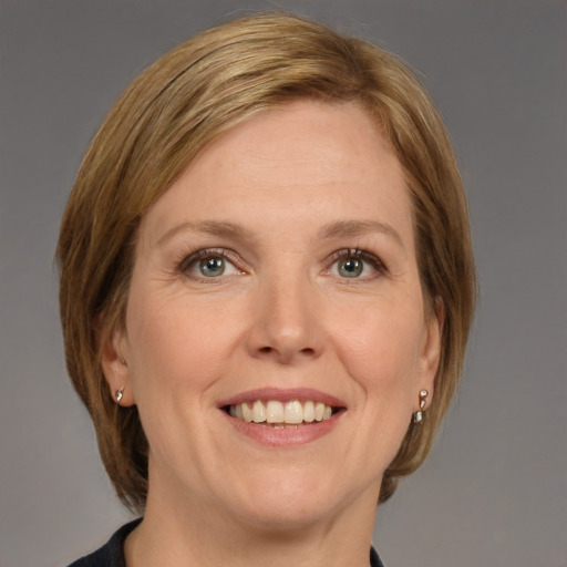 Joyful white adult female with medium  brown hair and grey eyes