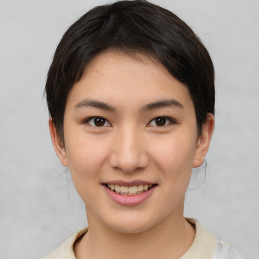 Joyful asian young-adult female with short  brown hair and brown eyes