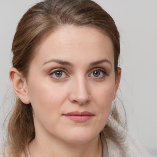 Joyful white young-adult female with medium  brown hair and grey eyes