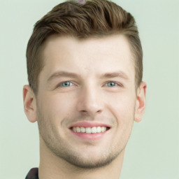 Joyful white young-adult male with short  brown hair and grey eyes