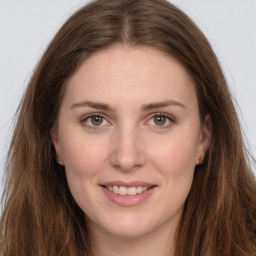 Joyful white young-adult female with long  brown hair and green eyes