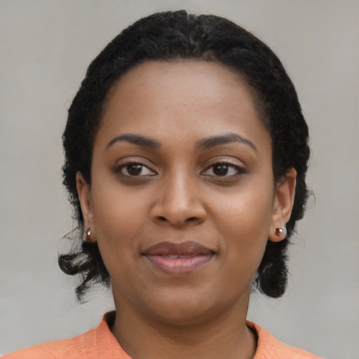 Joyful black young-adult female with medium  black hair and brown eyes
