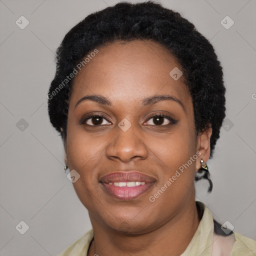 Joyful black young-adult female with short  black hair and brown eyes