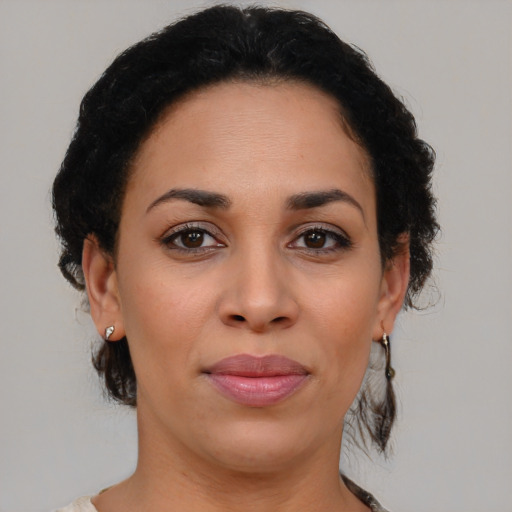 Joyful black young-adult female with medium  brown hair and brown eyes