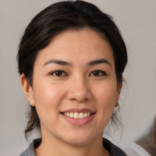 Joyful white young-adult female with medium  brown hair and brown eyes