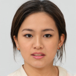 Joyful asian young-adult female with medium  brown hair and brown eyes