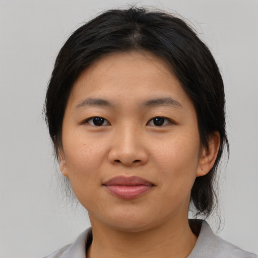 Joyful asian young-adult female with medium  brown hair and brown eyes