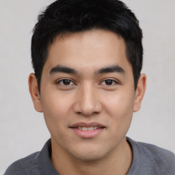 Joyful asian young-adult male with short  black hair and brown eyes