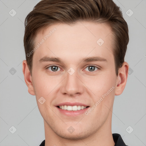 Joyful white young-adult male with short  brown hair and grey eyes