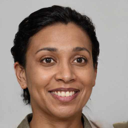 Joyful latino adult female with short  brown hair and brown eyes