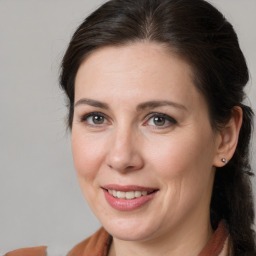 Joyful white adult female with medium  brown hair and brown eyes