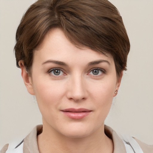 Joyful white young-adult female with short  brown hair and grey eyes